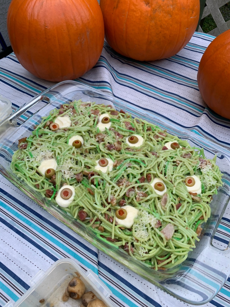 Green spaghetti with "eyeballs"